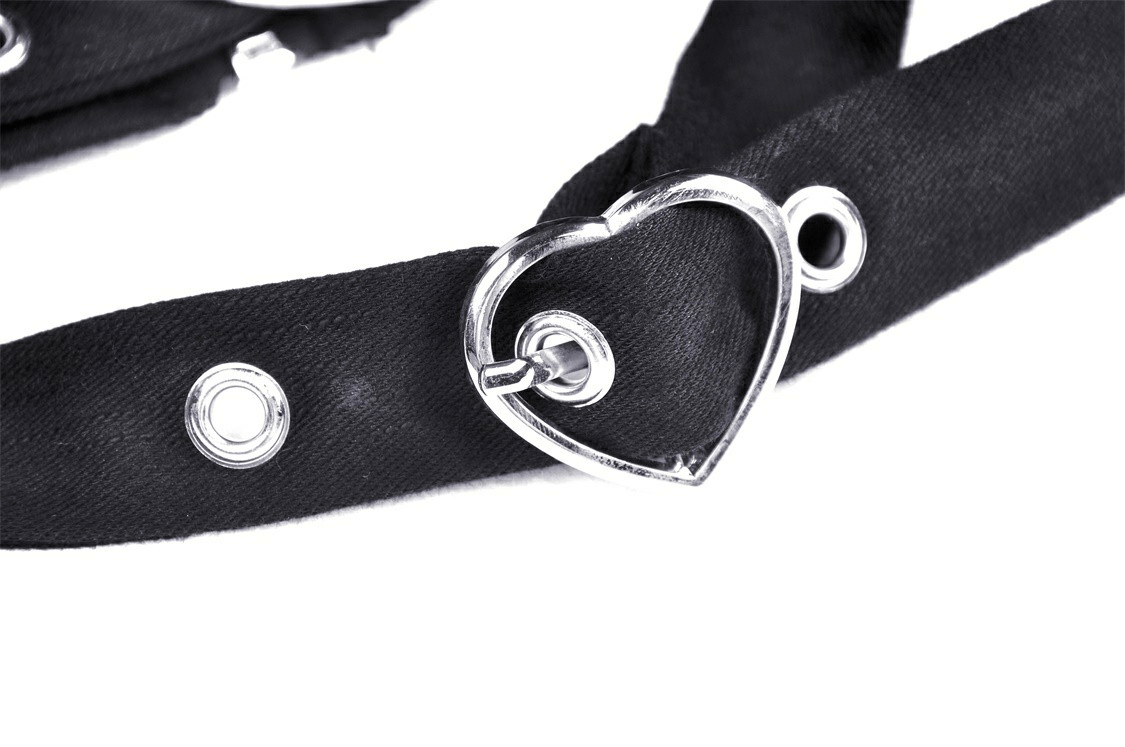 Black belt with heart-shaped buckle detail, perfect for adding a chic accent to stylish outfits.