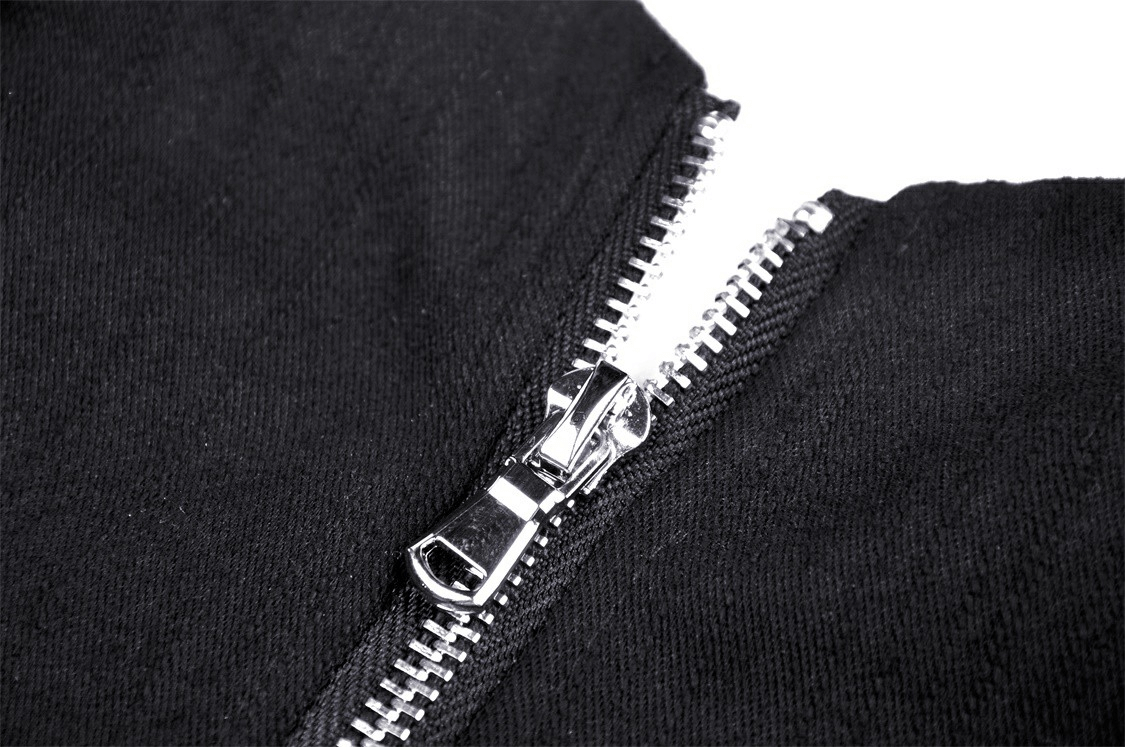 Close-up of sleek black zipper on trendy crop top with chic styling.