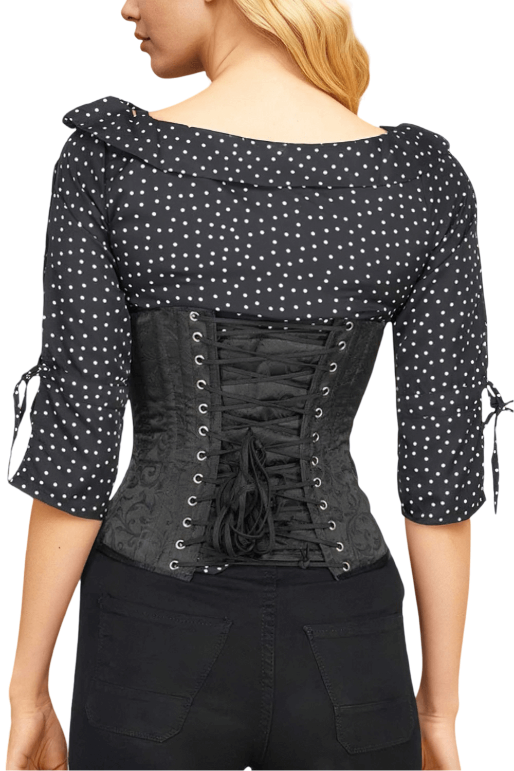 Woman wearing a sleek black brocade underbust corset with steel boning and polka dot blouse.