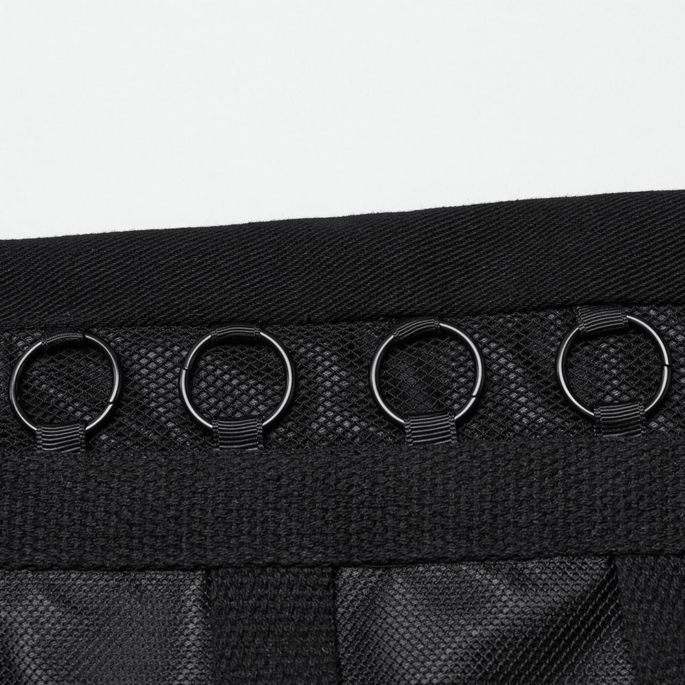 Close-up of sleek black pants featuring punk-style metal loops and vertical striped mesh detailing.