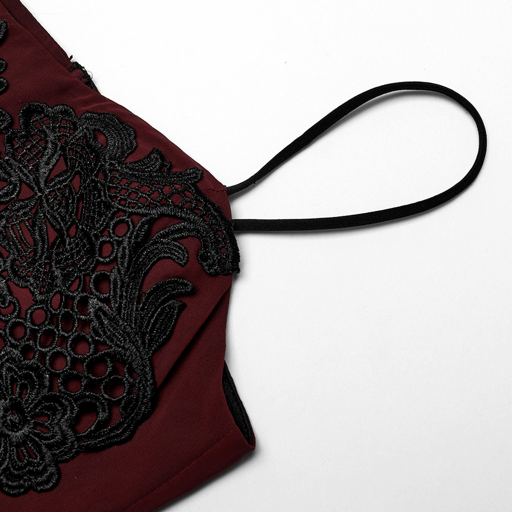 Close-up of the burgundy dress showing intricate black floral embroidery and adjustable straps.