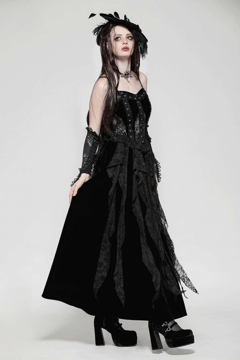 Gothic elegance in a black lace and velvet corset dress with ruffled details and flowing skirt.