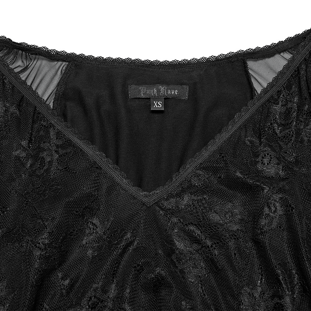 Close-up of the deep V-neckline and tag of a Gothic lace dress with sheer fabric details.