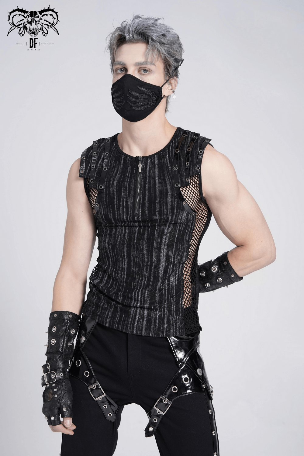Model wearing a sleeveless gothic top with mesh sides, zipper front, and punk accessories.