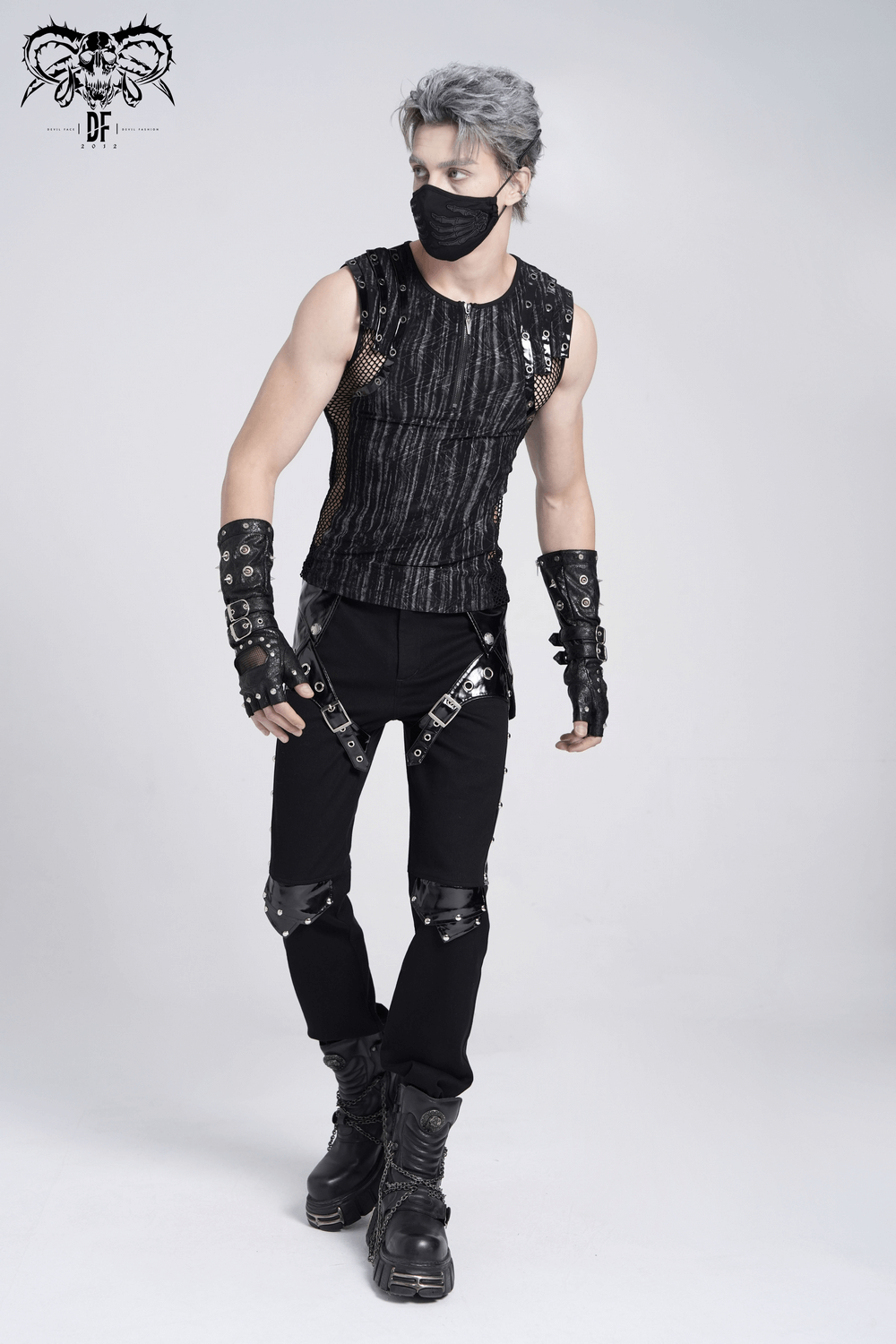 Model wearing a sleeveless black gothic top with mesh accents, buckle straps, and grunge-style pants for a punk look.