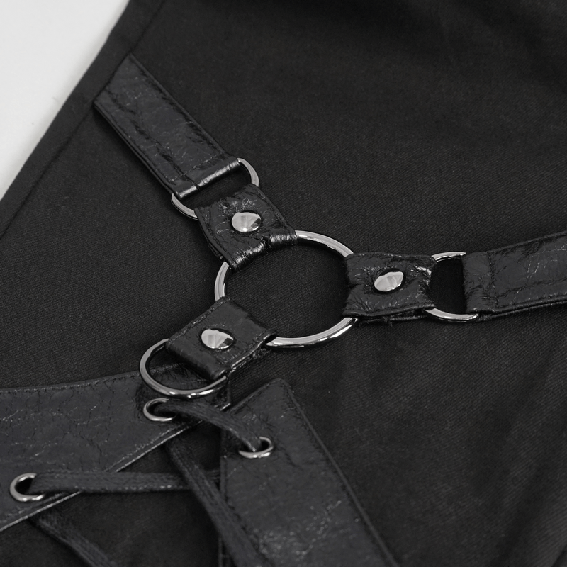 Close-up of edgy black lace-up decoration and rings on punk style slim-fit pants.