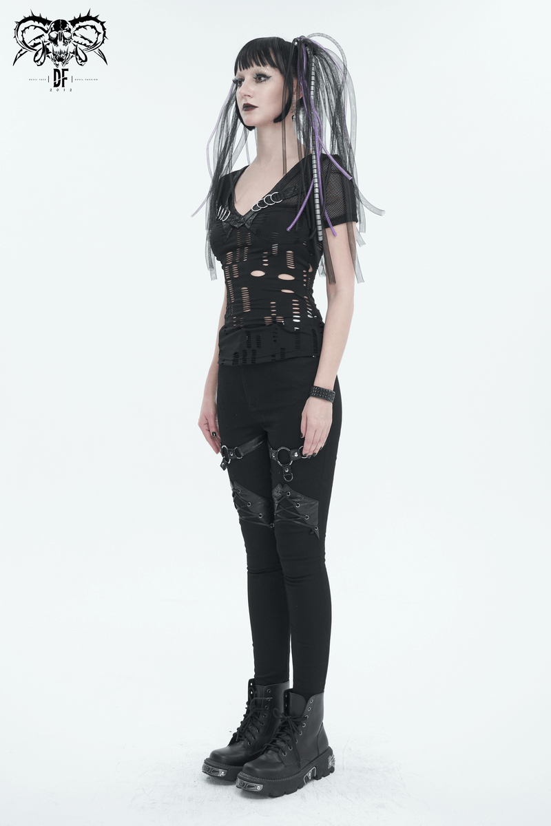 Edgy woman in slim-fit black pants with chains and lace-up details, showcasing punk style fashion.