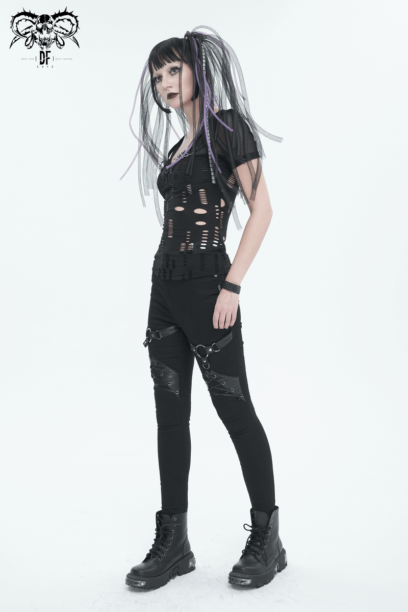Edgy women's punk style model wearing slim fit pants with rings and lace-up details, showcasing bold fashion.