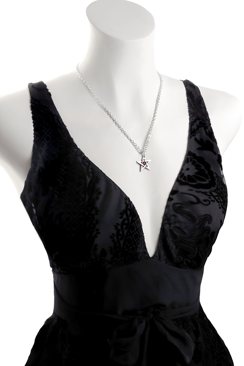 Small crystal pentagram pendant with red Austrian crystal displayed on a stylish black dress.