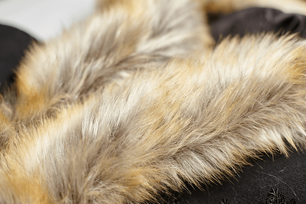 Close-up of luxurious faux fur trim on a sophisticated black Gothic cloak, showcasing soft textures and elegant details.