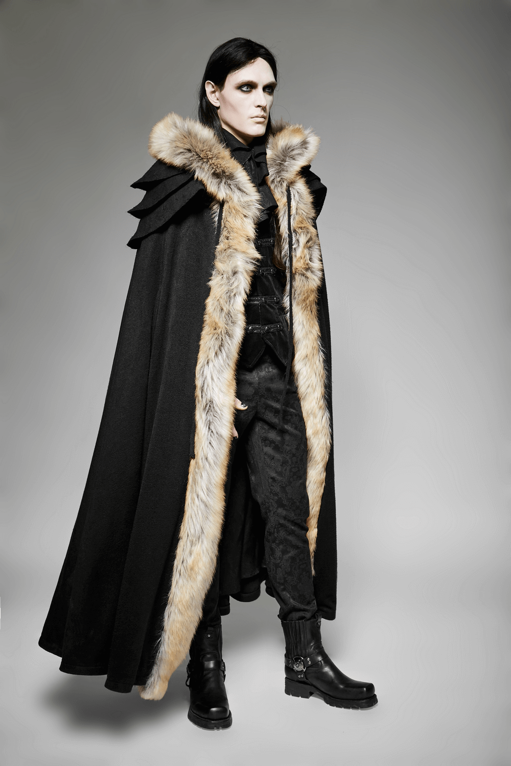 Enigmatic black Gothic cloak with faux fur trim and grand collar on a model, showcasing shadowy elegance.