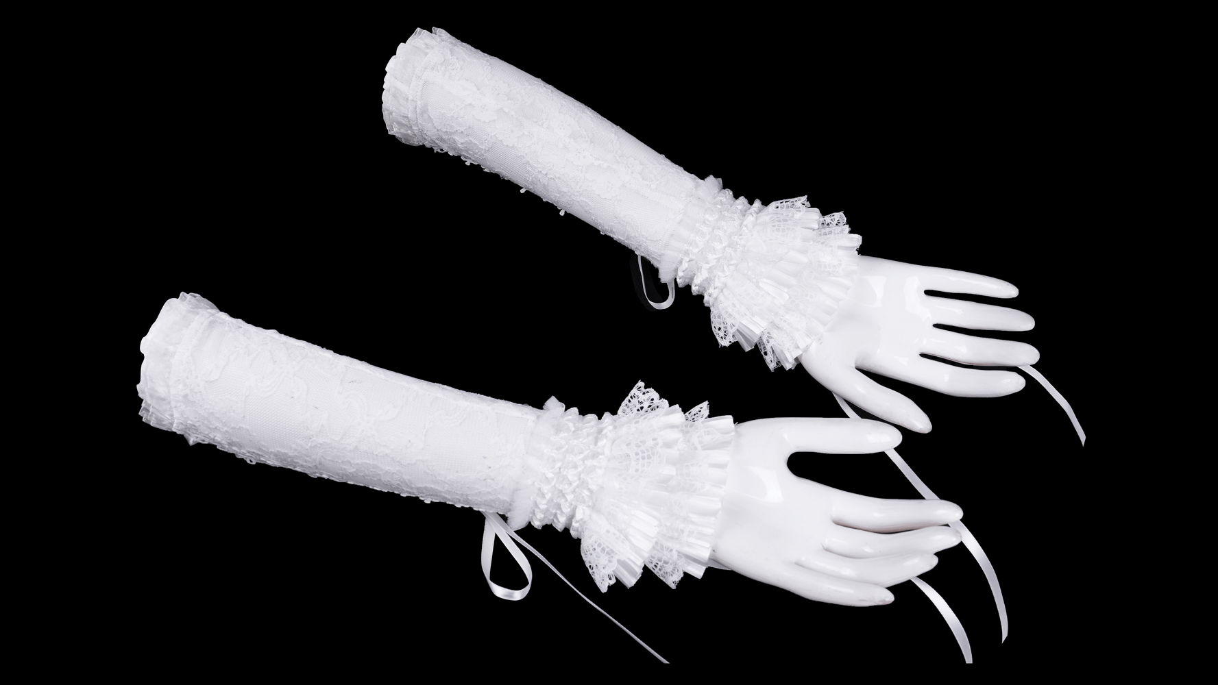 Elegant bridal lace fingerless gloves with ribbon and tulle accents, perfect for a chic wedding look.