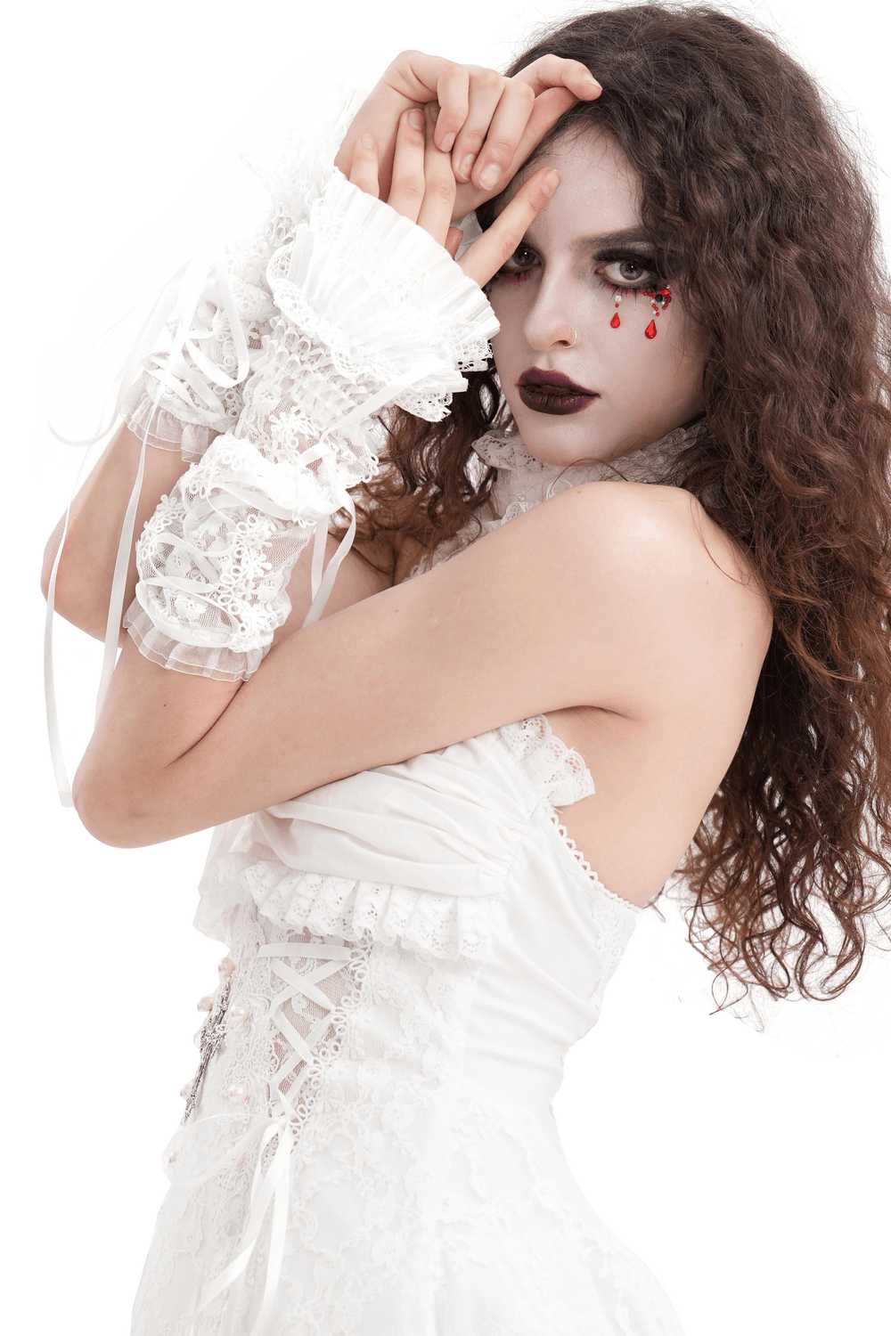 Elegant bridal model wearing fingerless lace gloves with ribbons and a white wedding dress, showcasing sophistication and style.