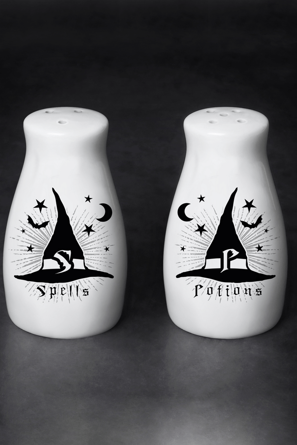 Gothic ceramic salt and pepper shakers featuring witch hats, moons, and stars for a magical kitchen touch.