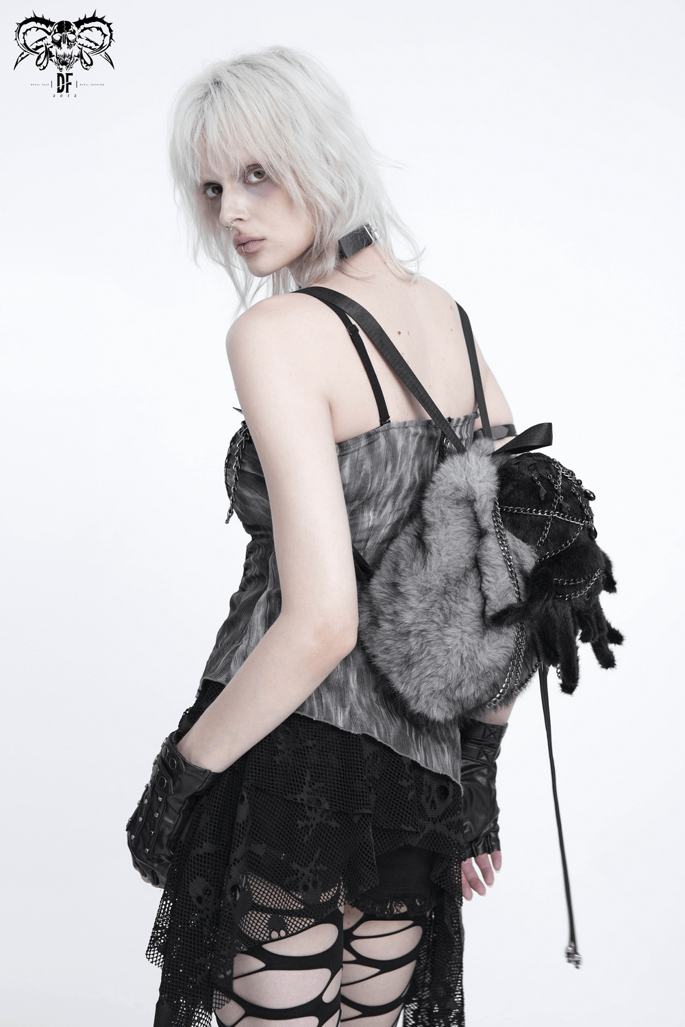 A model showcasing the Spider Backpack with Faux Fur and Metal Chain Details against a plain background.