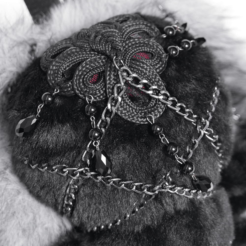 Close-up of Spider Backpack with Faux Fur and Metal Chain Details, showcasing intricate chain and charm design.