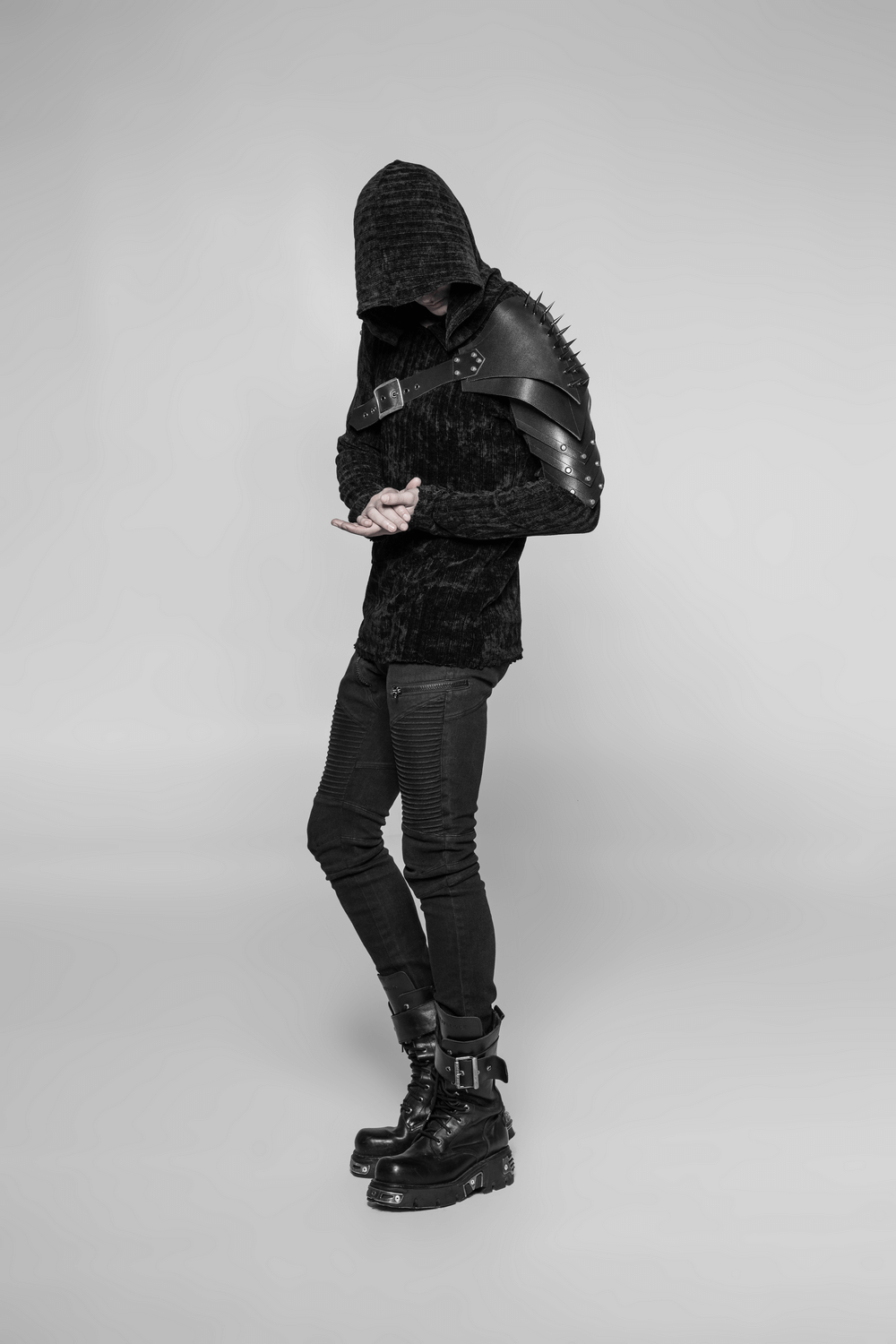 Spiked punk shoulder armor strap with metal buckle on hooded model, embracing edgy style with PU leather and retro nail accents.