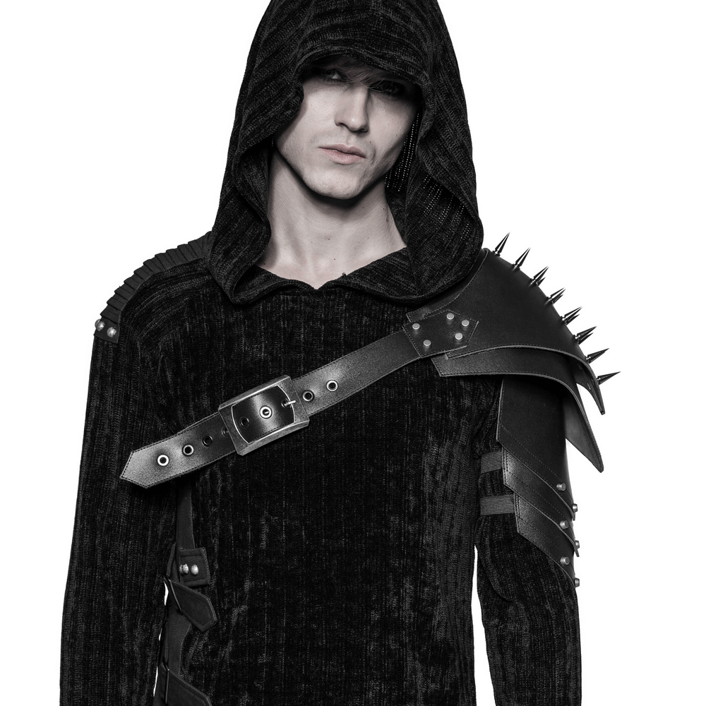 Punk shoulder armor strap with spikes and metal buckle on model wearing a hooded outfit.