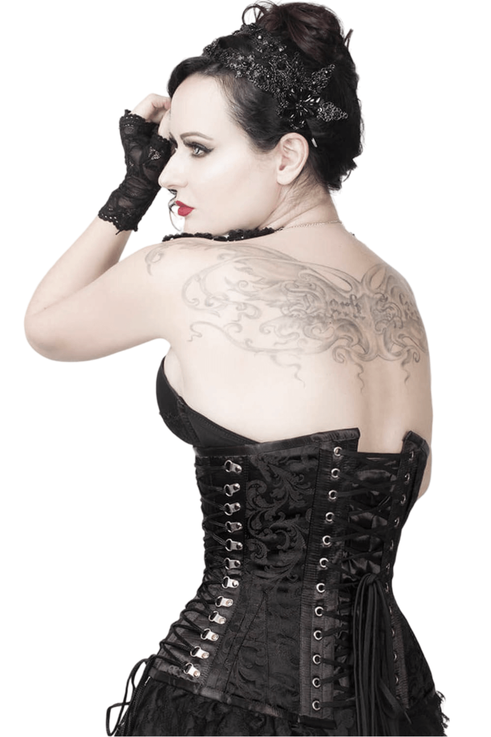 Back view of a model in a black brocade Gothic underbust corset with intricate lacing and tattoo detail.