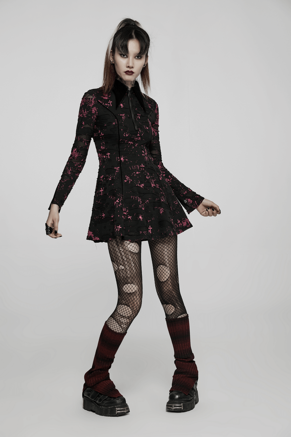Chic Gothic splatter print dress with zipper and lace-up back, paired with fishnet tights and platform shoes.