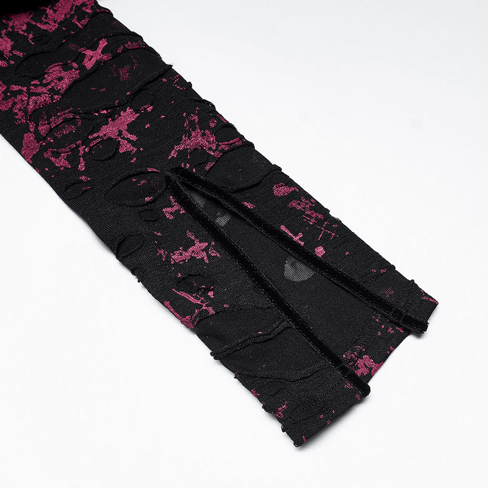 Close-up of the split cuff detail on a black and pink splatter print gothic dress.
