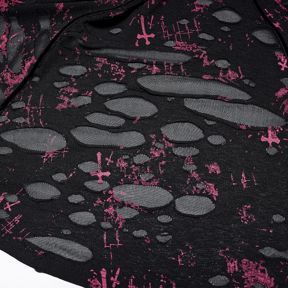 Close-up of pink splatter print on black fabric, showcasing the unique Gothic design with ripped details.