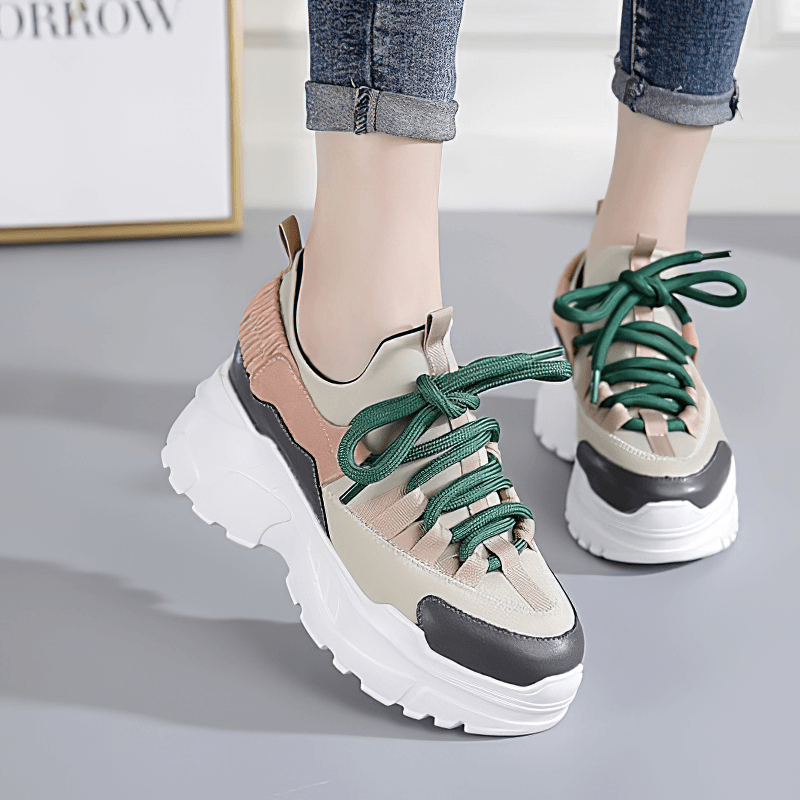 Stylish women's breathable platform running sneakers with colorful green laces, perfect for a trendy gothic outfit.