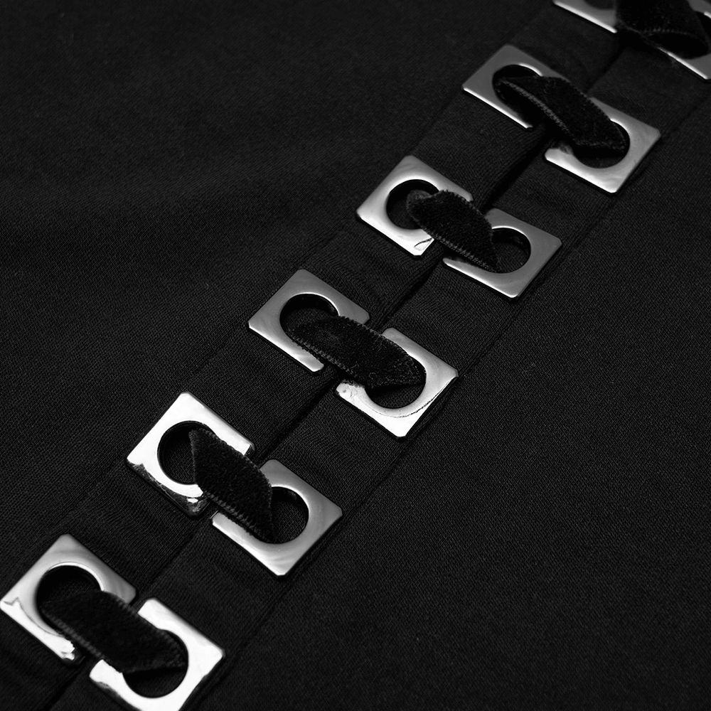 Close-up of square eyelet accents on a black punk crop top, showcasing edgy laced-up detail.