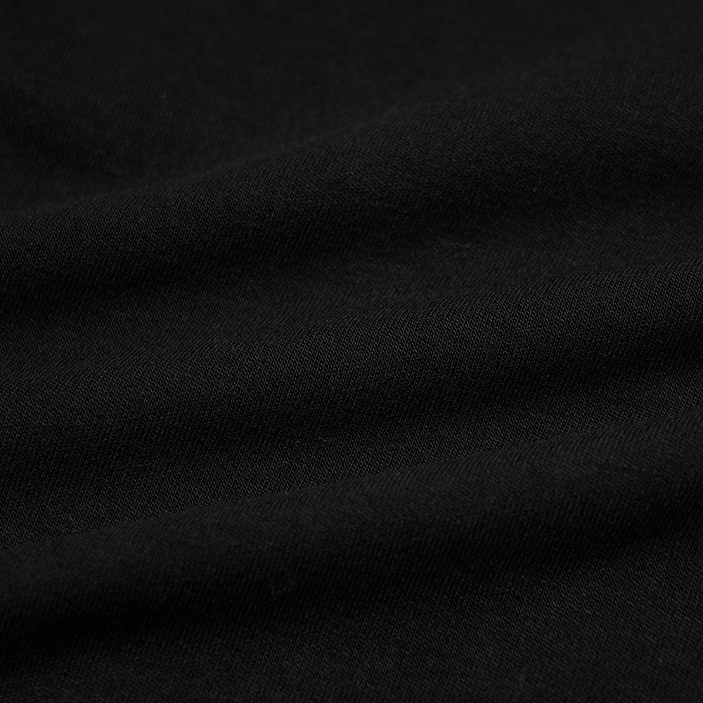 Close-up of soft black fabric, showcasing the quality material used in the edgy punk crop top.