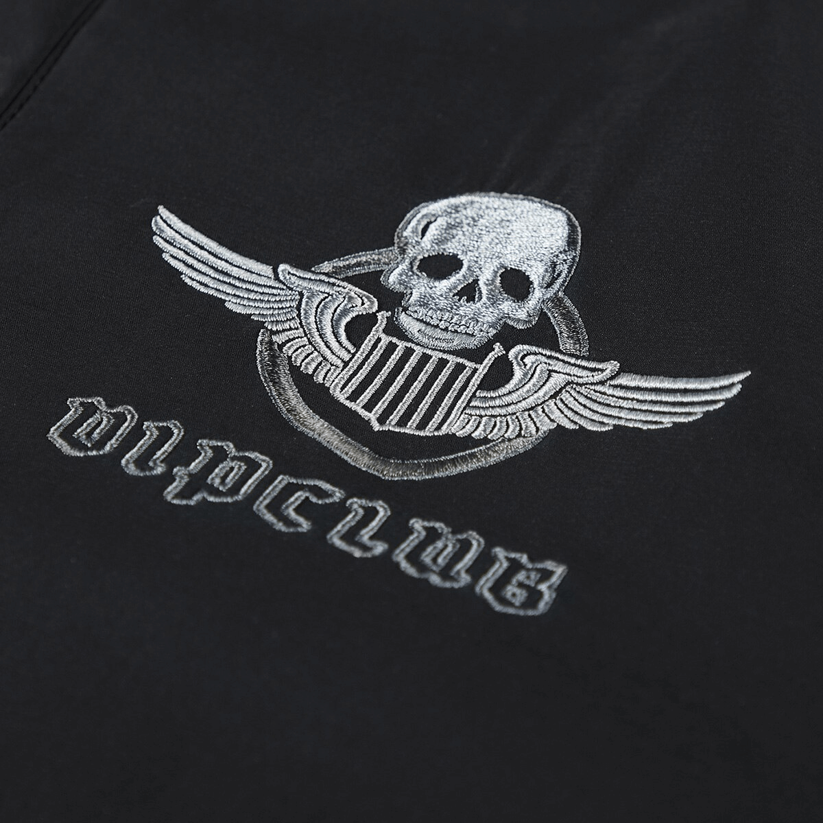 Skull embroidery with wings on a tactical bomber jacket, stylish design for the modern man.