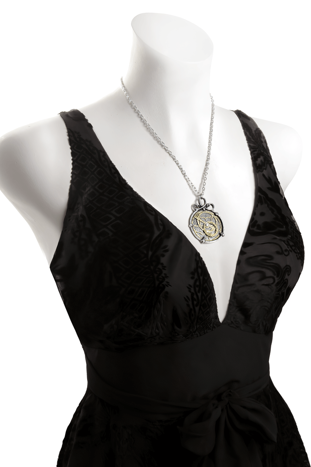 Steampunk Anguistralobe pendant displayed on a black dress, highlighting intricate brass and pewter design.