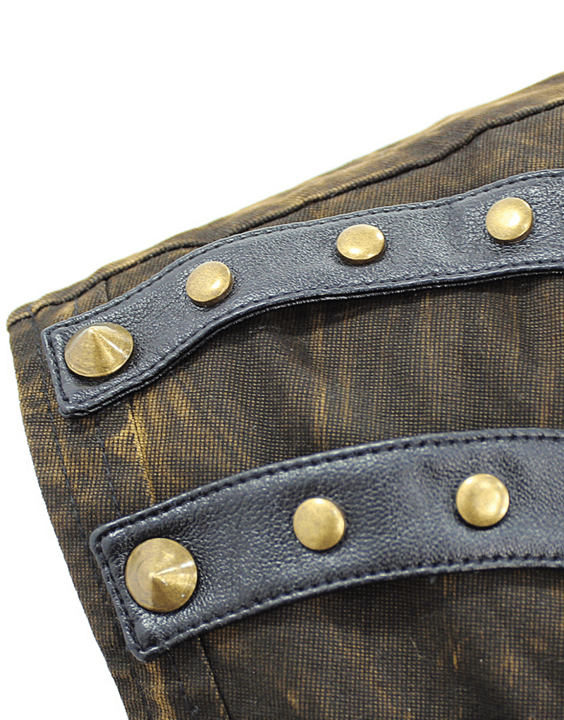 Close-up of steampunk vest detailing with bronze rivets and black straps on vintage fabric.