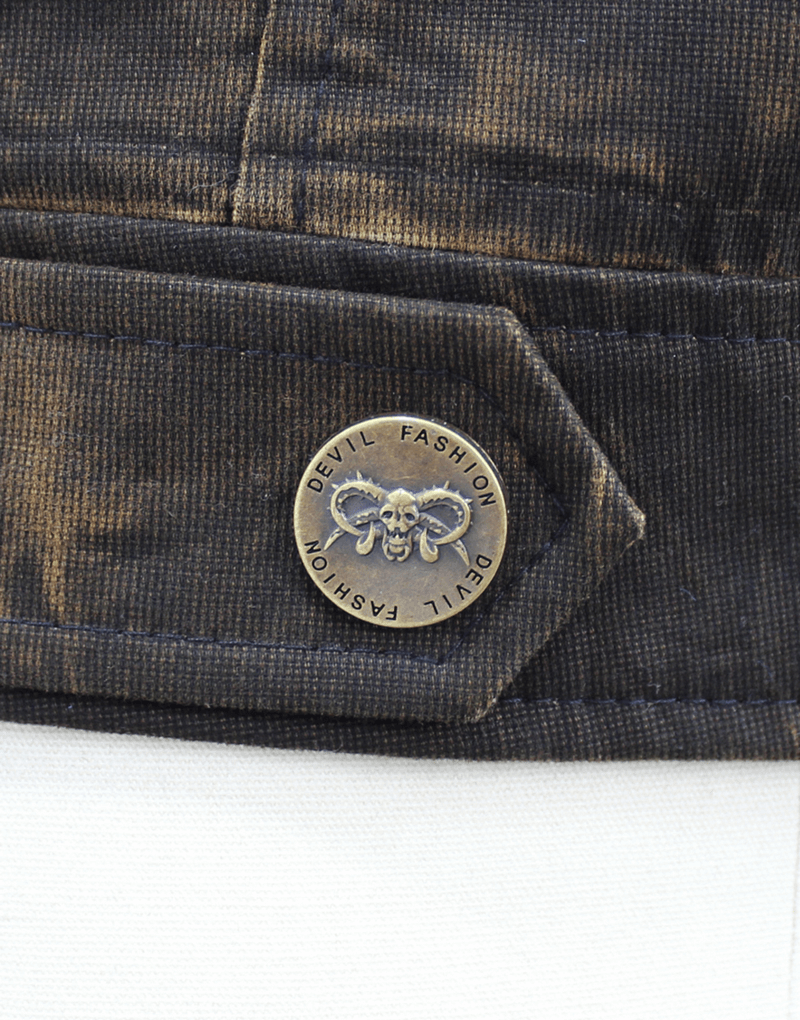Close-up of a vintage steampunk vest button featuring Devil Fashion branding and skull design.