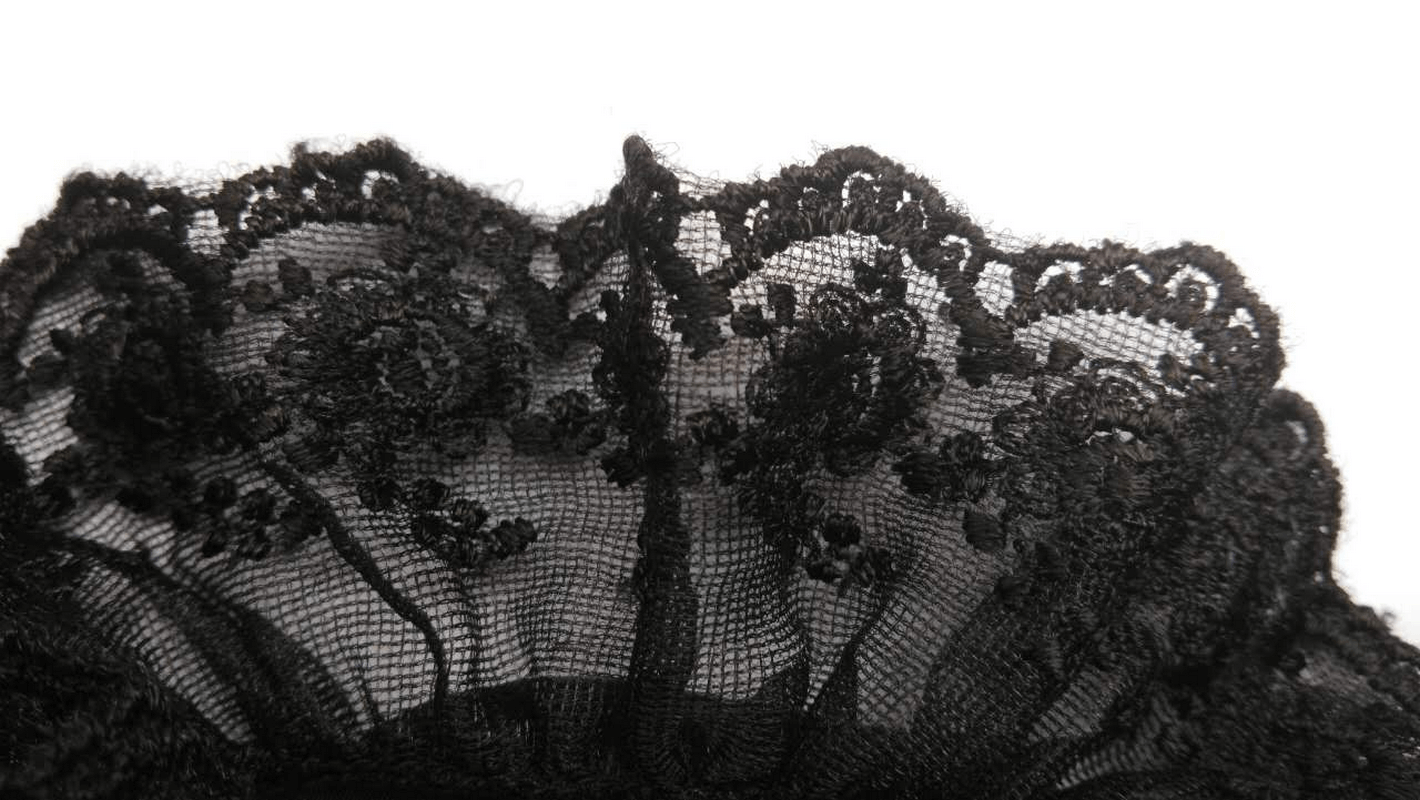 Close-up of intricate black lace trim showcasing detailed floral patterns for steampunk fashion.