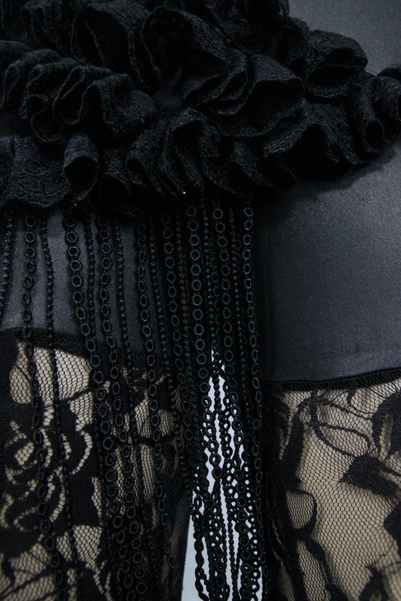 Close-up of steampunk black lace leggings featuring PU leather ruffles and decorative chains for a stylish look.