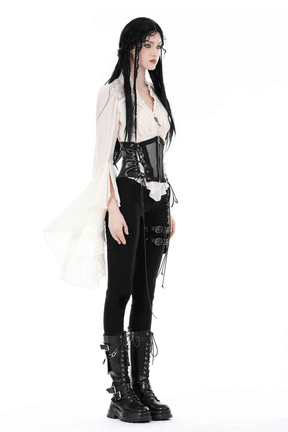 Model wearing a steampunk blouse with bell sleeves, corset, and black boots for a dramatic Victorian-inspired look.
