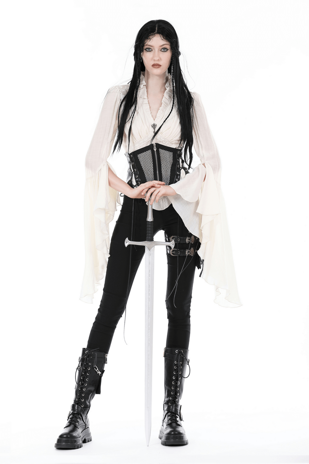 Steampunk blouse with bell sleeves, lace details, and a corset; paired with black pants and boots, holding a sword.