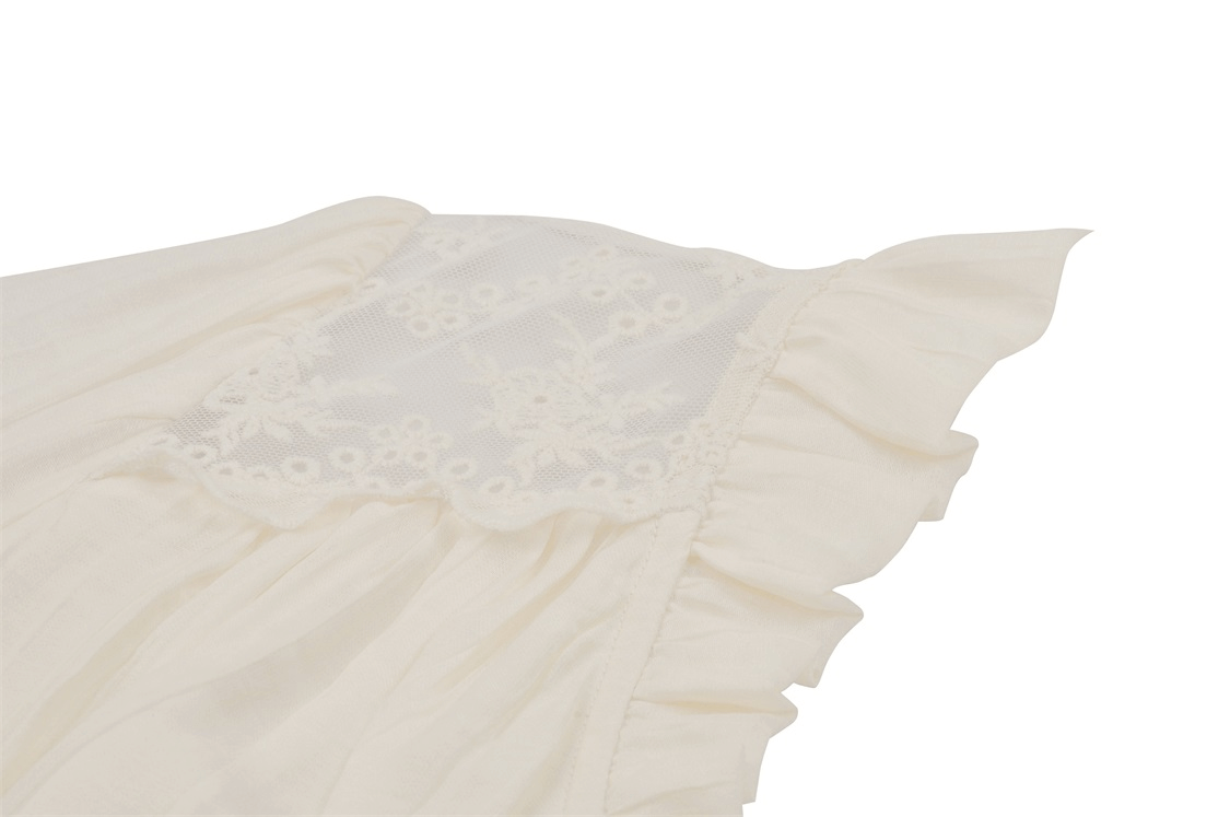Close-up of a romantic steampunk blouse with lace detailing and ruffled sleeves in soft white fabric.