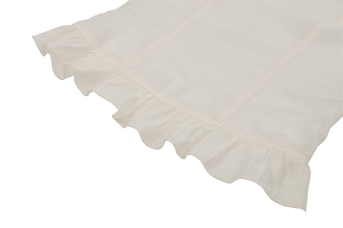 Close-up of romantic white blouse with delicate ruffled hem, perfect for steampunk fashion.