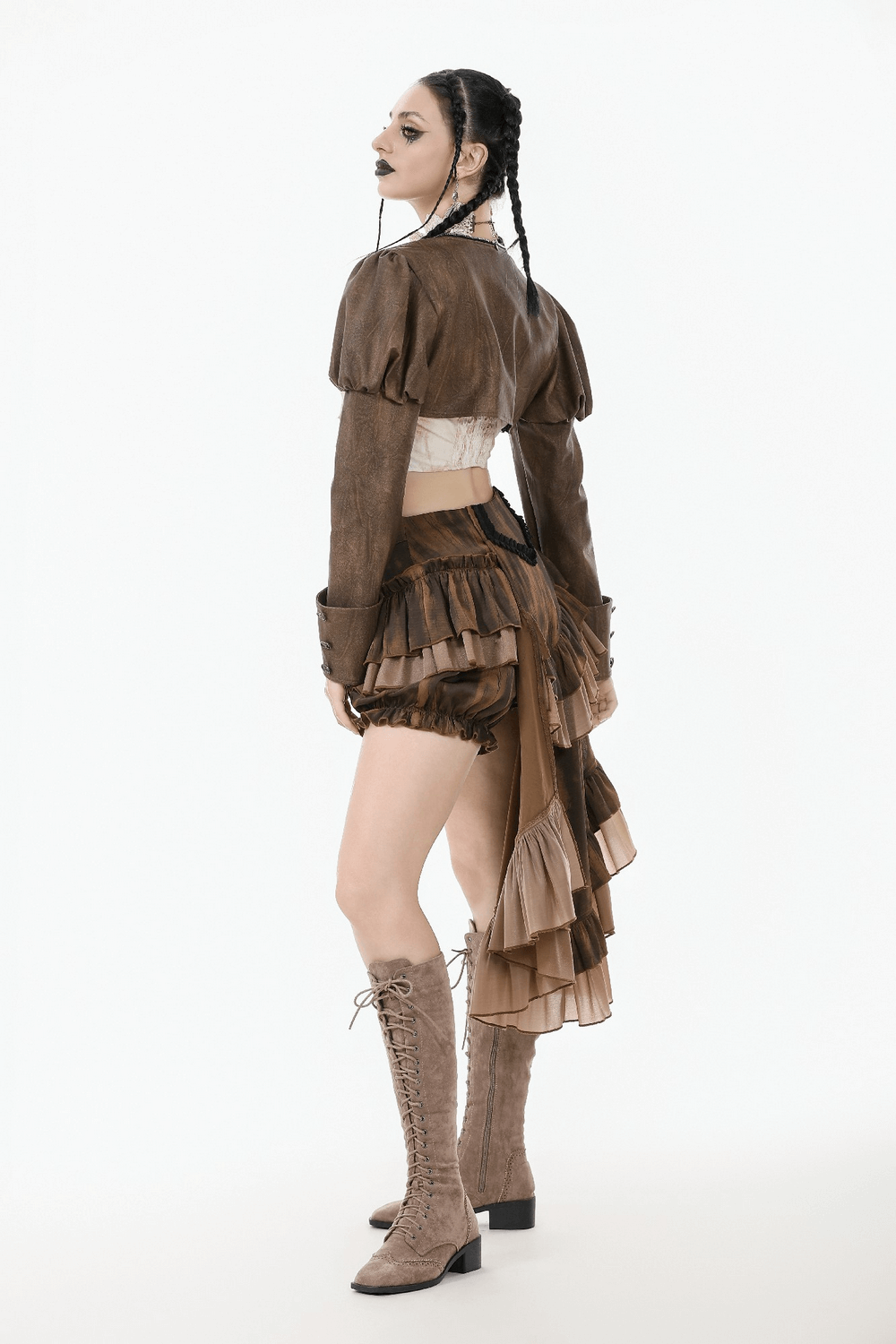 Model wearing a vintage brown PU leather bolero shrug with puffed shoulders, paired with a trendy skirt and knee-high boots.