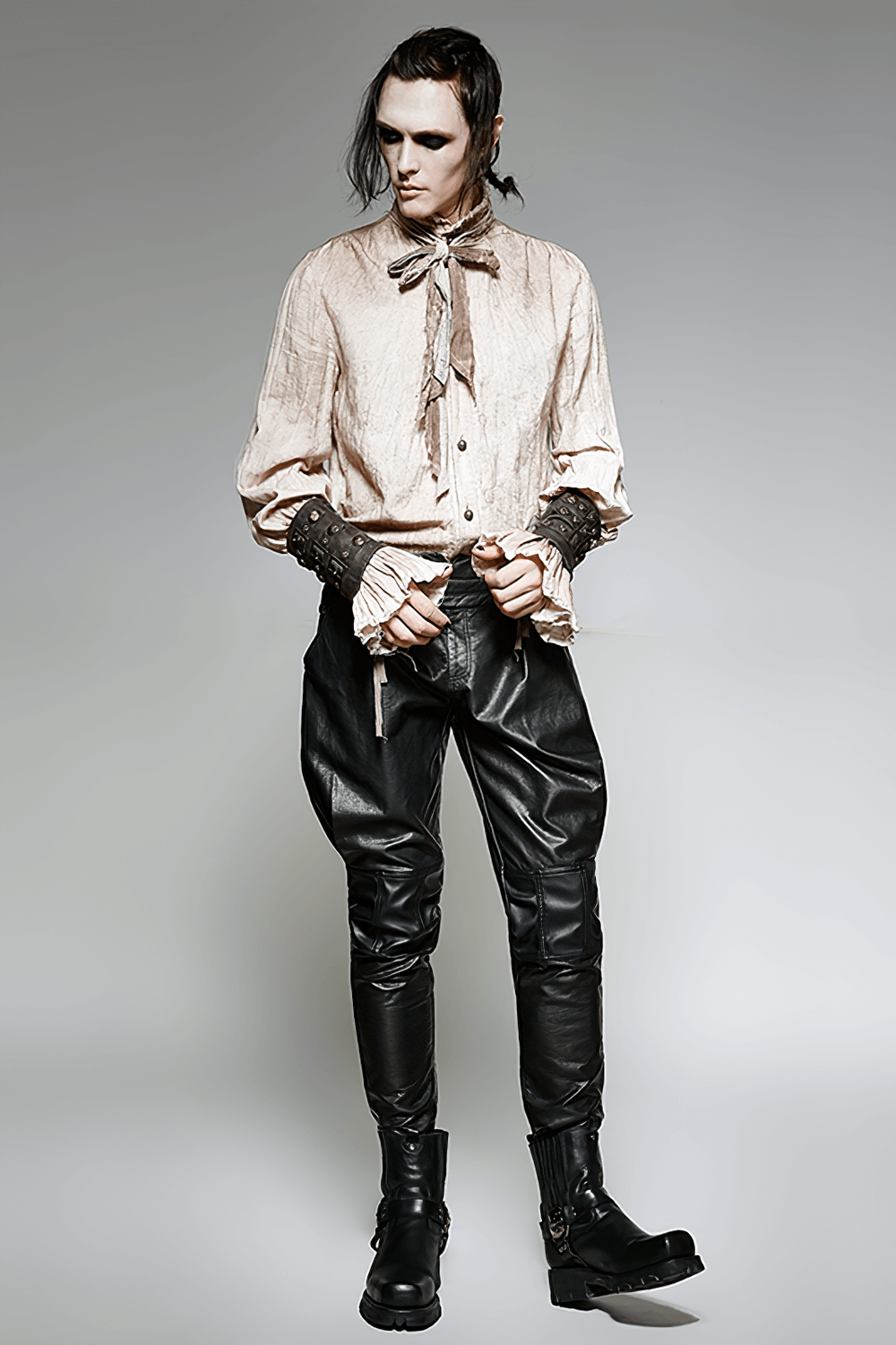 Model showcasing a gothic steampunk outfit with a textured shirt and stylish leather pants.