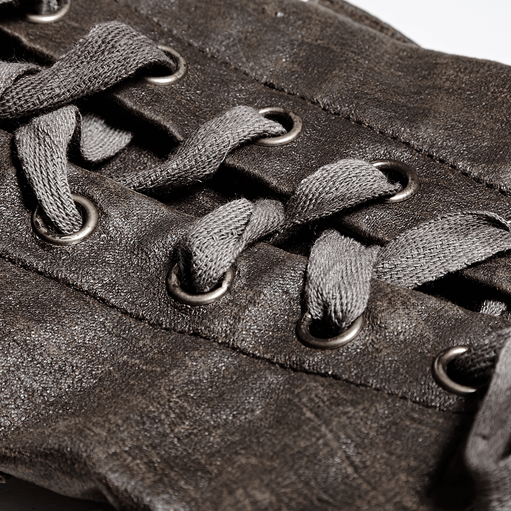 Close-up of adjustable dark brown steampunk bracers with lace-up straps and rivet details.
