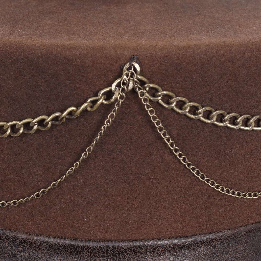 Close-up of steampunk brown top hat featuring decorative chains on a soft felt surface.