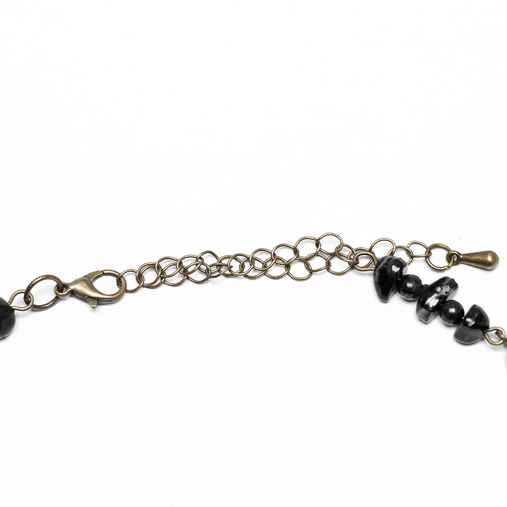 Close-up of the chain clasp and natural stones on a steampunk butterfly necklace, showcasing intricate design.