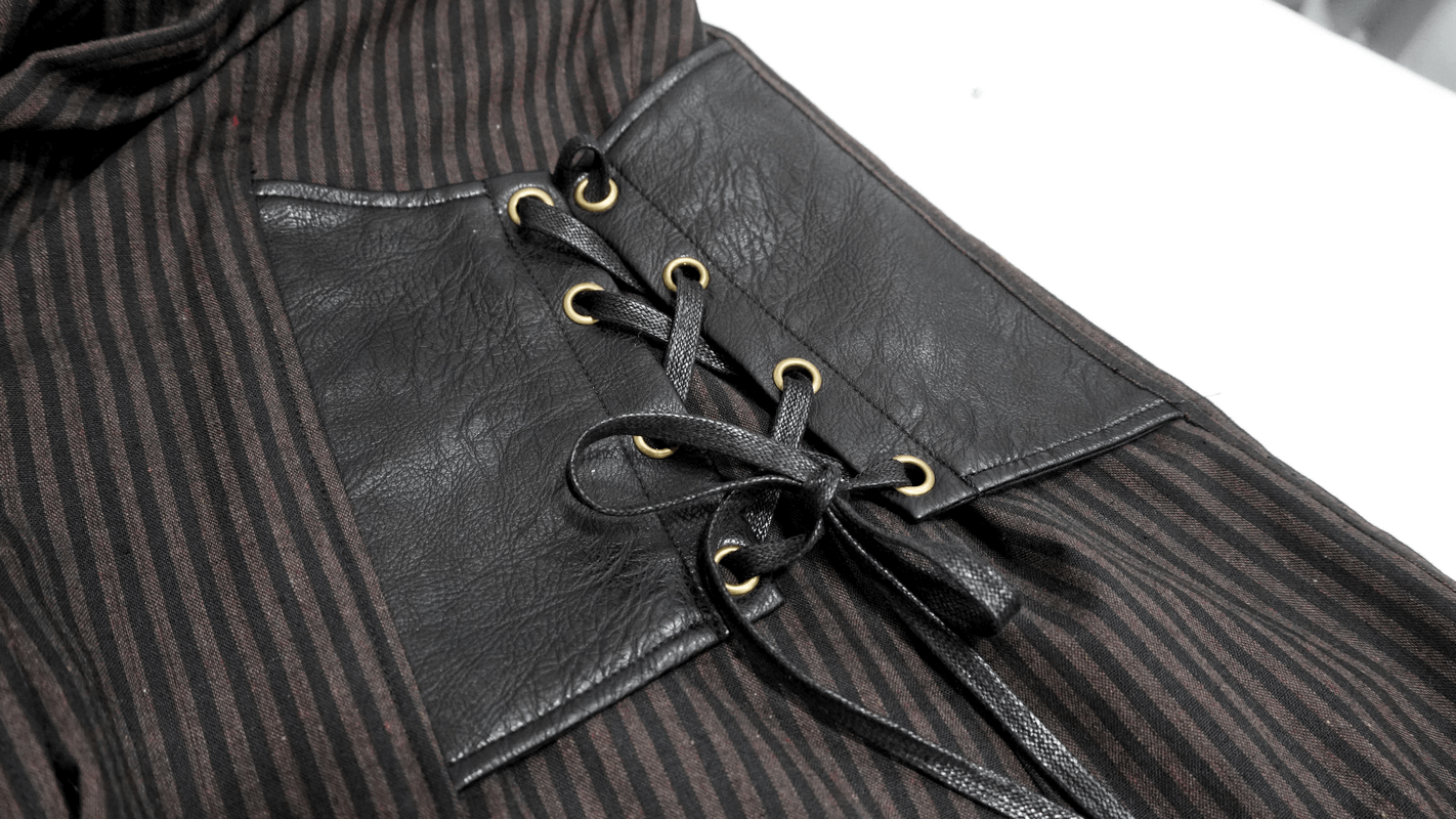 Close-up of steampunk men's vintage striped shirt with PU leather insert and lace-up detail.