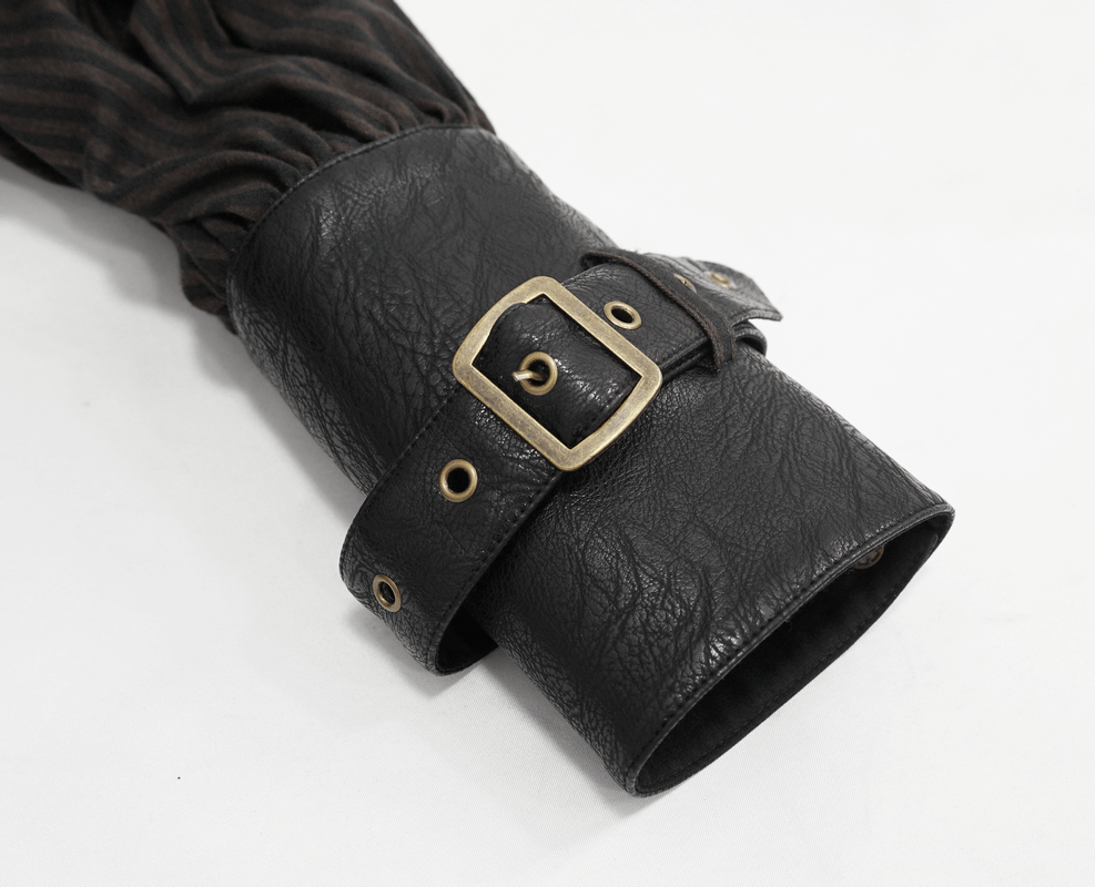 Close-up of a black PU leather cuff with a buckle design from a steampunk style shirt.