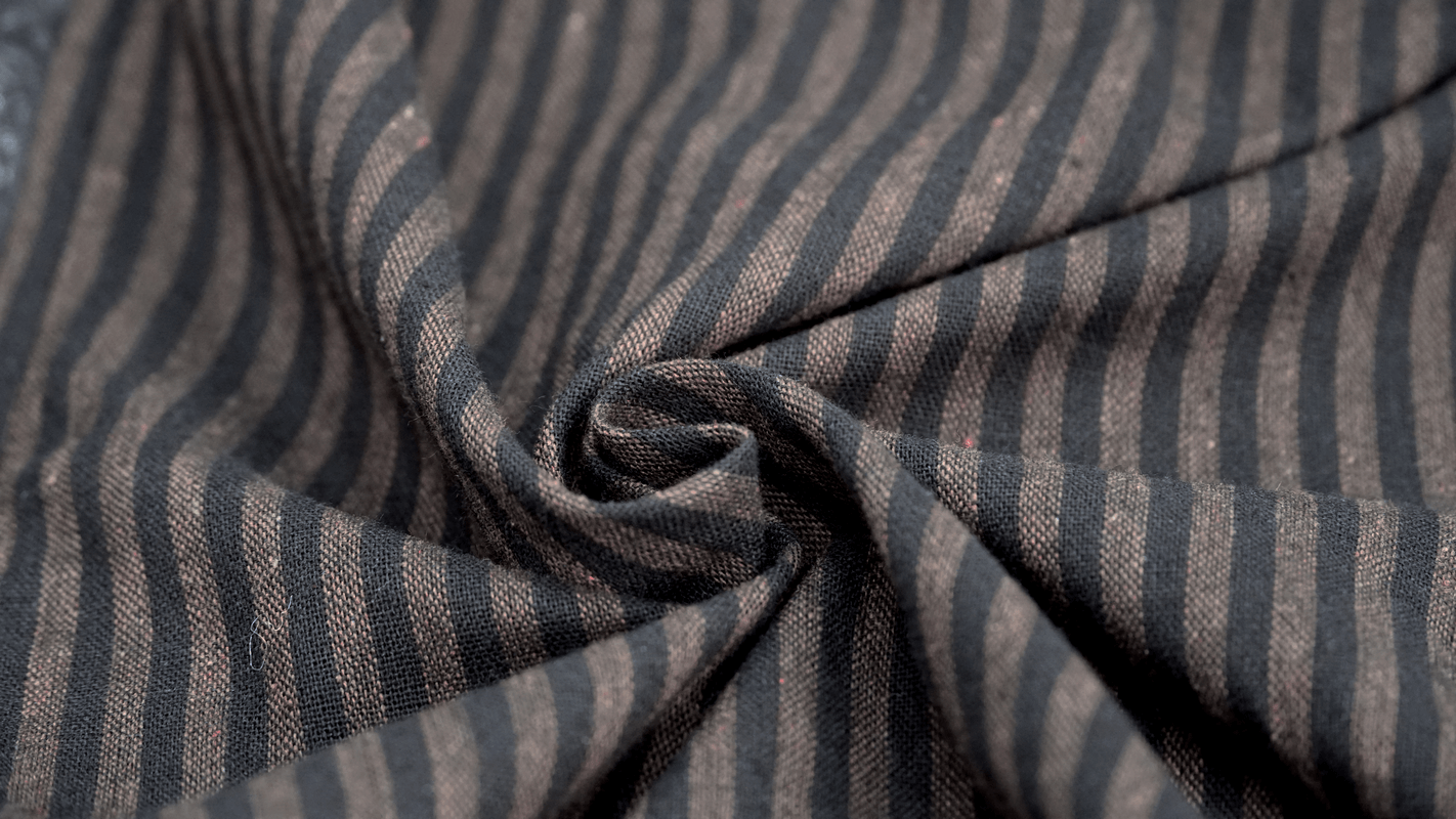 Close-up of steampunk style striped fabric showcasing the intricate texture and vintage appeal.