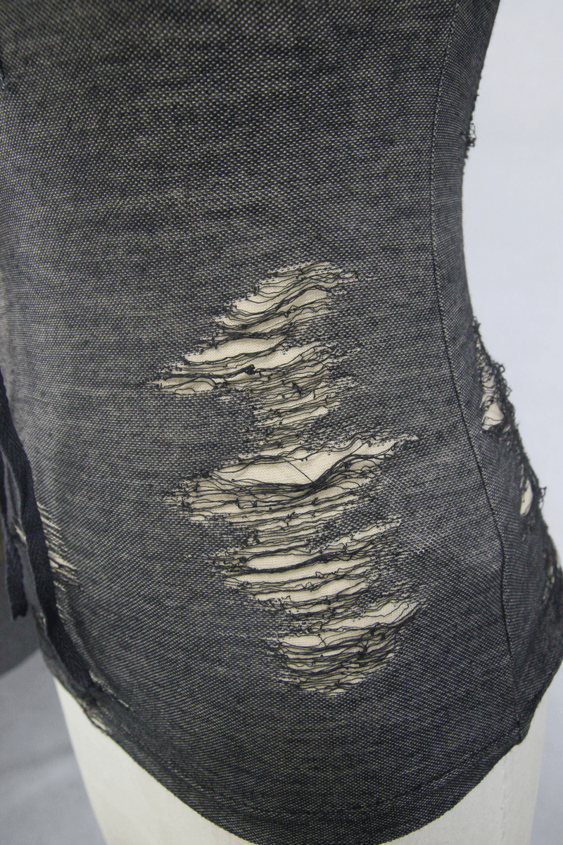 Close-up of a frayed black steampunk sleeveless tank top showcasing stylish torn inserts.