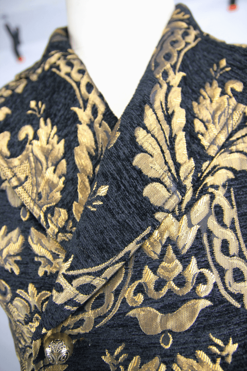 Close-up of gothic men's waistcoat with gold embroidery on black fabric, showcasing intricate patterns and vintage style.