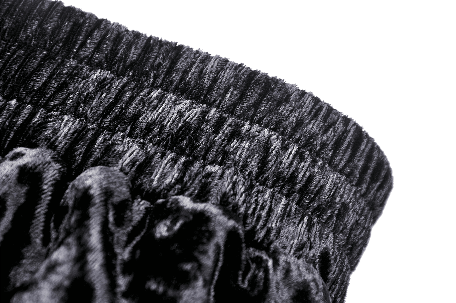 Close-up of the ruffled, textured waistband of a black gothic maxi skirt.